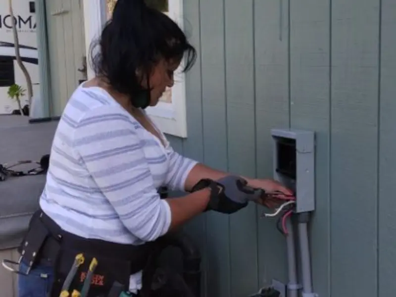 Licensed electrician wiring an exterior subpanel in Millington